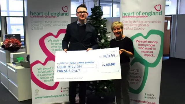 Staff with the £4m cheque