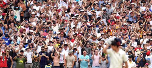 England fans celebrate Cook century