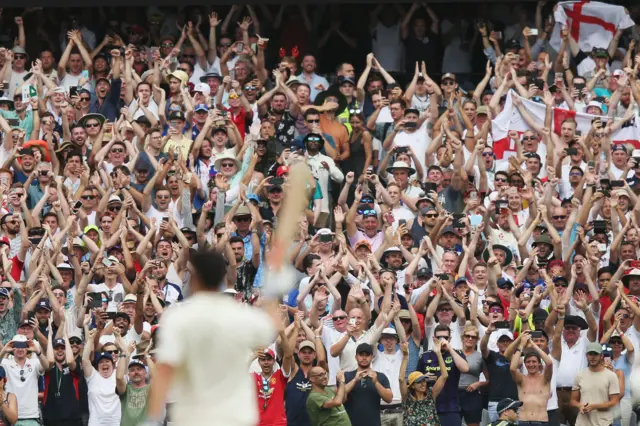 England fans celebrate Cook 200