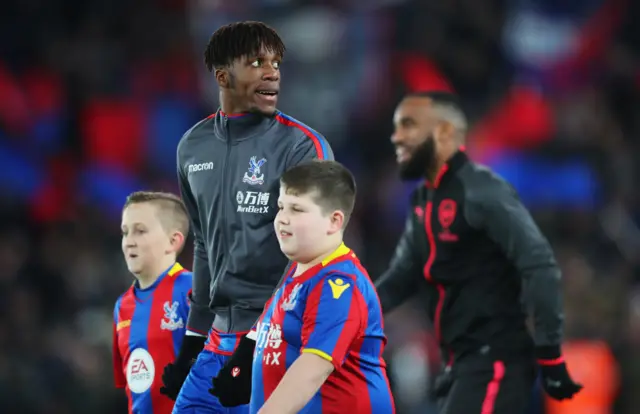 Wilfried Zaha walks onto the pitch at Selhurst Park