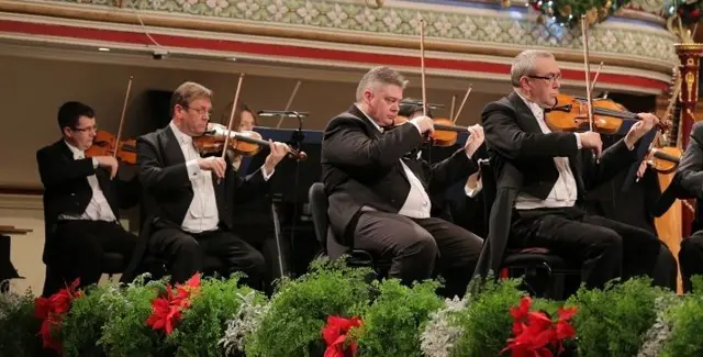 Violinists playing in an orchestra.