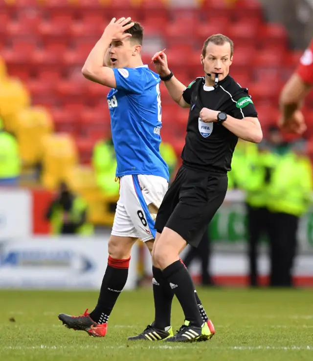 Ryan Jack looks aghast after receiving a red car from Willie Collum