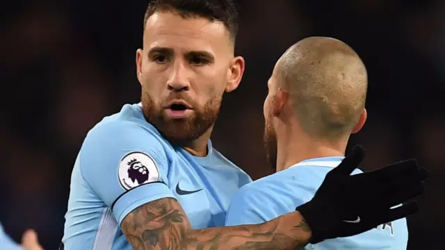 Nicolas Otamendi and David SIlva embrace at full-time