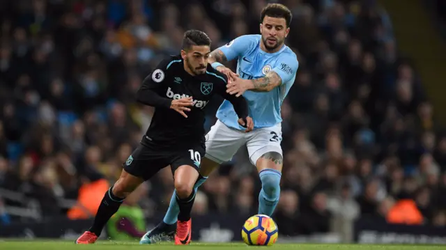 Manuel Lanzini takes on Kyle Walker