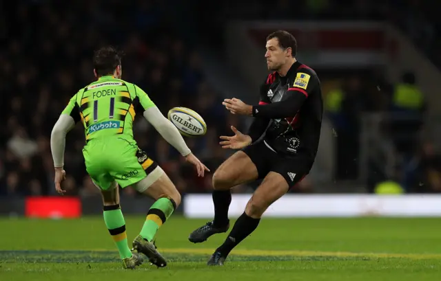 Tim Visser of Harlequins passes ahead of Ben Foden of Northampton