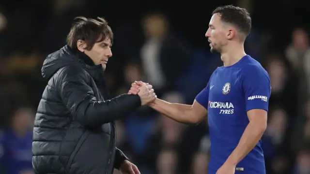 Antonio Conte, Manager of Chelsea shakes hands with Danny Drinkwater