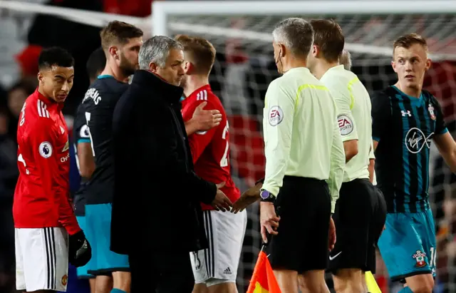 Jose Mourinho talks to referee Craig Pawson at the end of the match