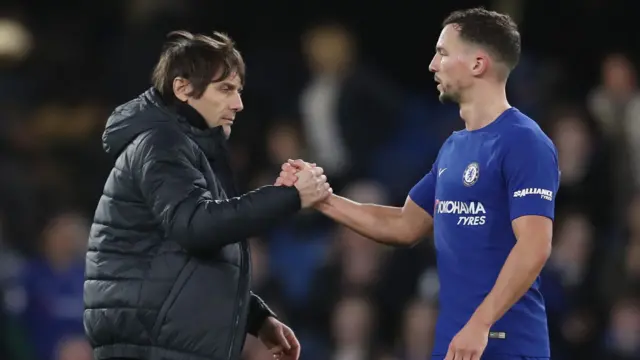 Antonio Conte, Manager of Chelsea shakes hands with Danny Drinkwater