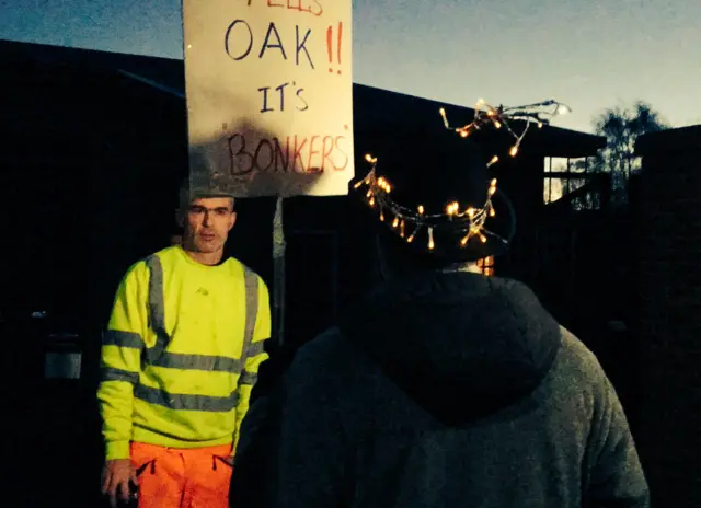 Protester talks to Acorn worker