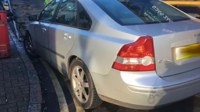 Illegally parked car being towed away