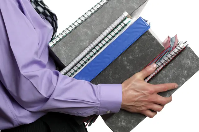 A man carrying files