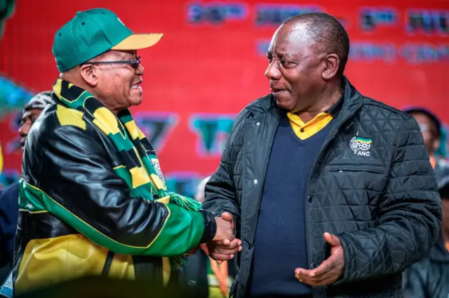 South African President Jacob Zuma (L) and South African Deputy President Cyril Ramaphosa (R) shake hands as they arrive to attend the opening session of the South African ruling party African National Congress (ANC) policy conference on June 30, 2017 in Johannesburg.