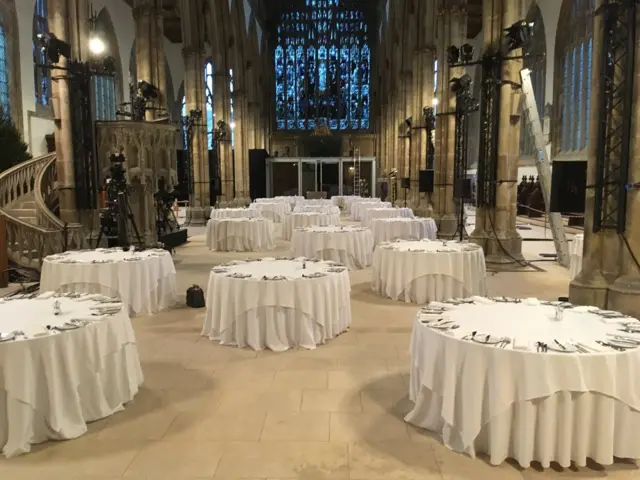 Tables in the Minster with cutlery and plates laid out