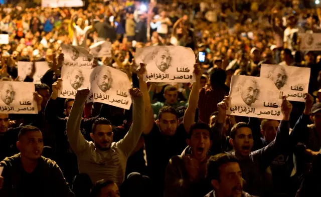 Protesters hold pictures of Nasser Zafzafi, leader of the 'Hirak' Rif region's protest movement, during a demonstration against corruption, repression and unemployment in the northern city of al-Hoceima on May 29, 2017.