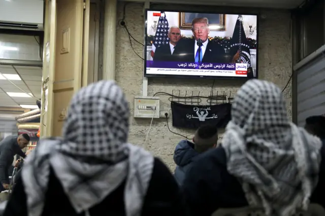 Palestinians watch a televised broadcast of Trump delivering an address where he is expected to announce that the United States recognises Jerusalem as the capital of Israel, in Jerusalem's Old City 6 December 2017