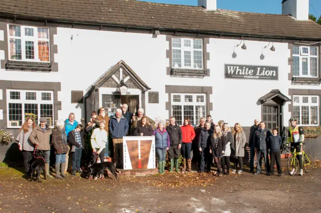 A crowd outside the White Lion pub in Ash