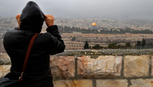 An individual looks over at the Old City of Jerusalem