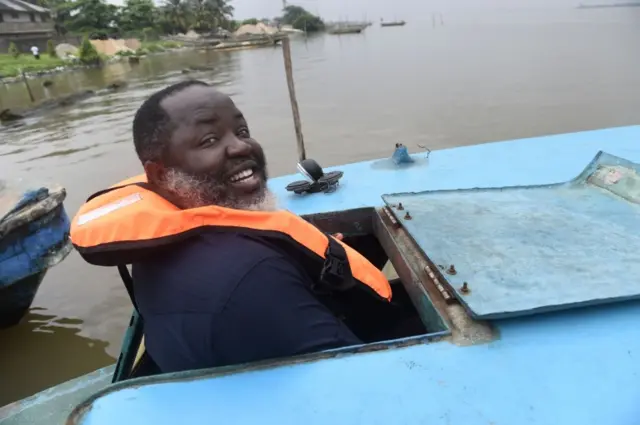 A man on a boat smiles for the camera