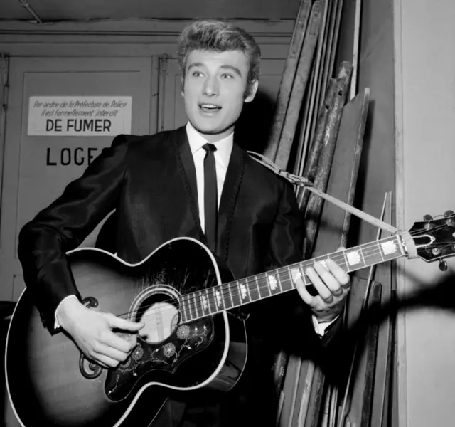 French singer Johnny Hallyday performing at the Olympia in Paris in 1964