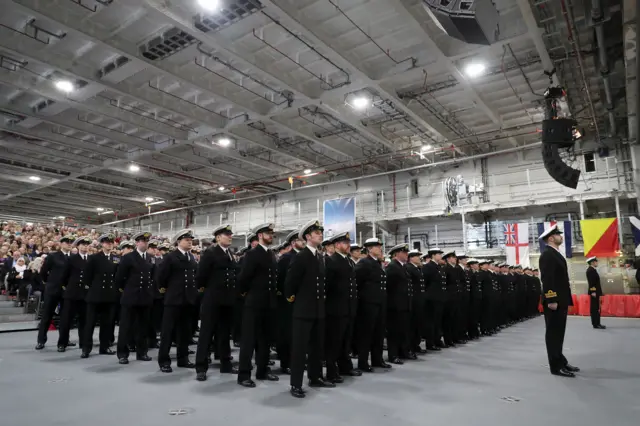 HMS Queen Elizabeth's ships company march on to parade at the commissioning of HMS Queen Elizabeth