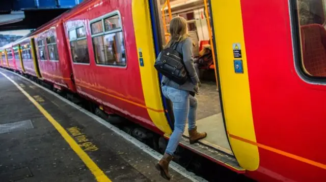 Woman getting on train