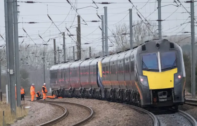 Engineers checking train at Helpston