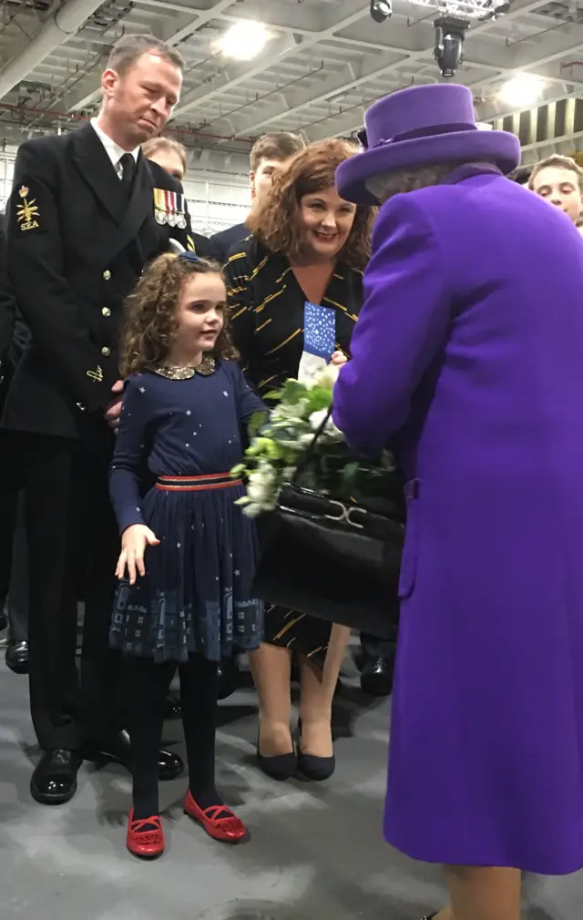 Queen being presented with flowers
