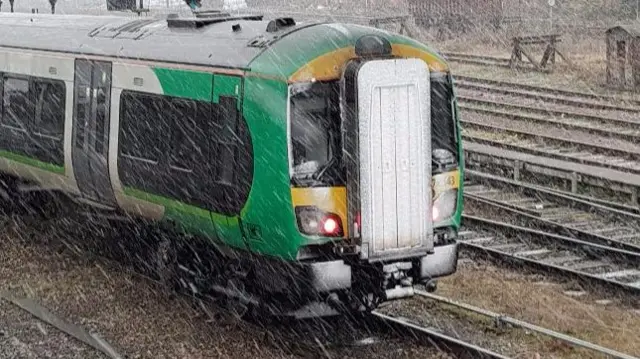 Snow falling on a train in Worcester