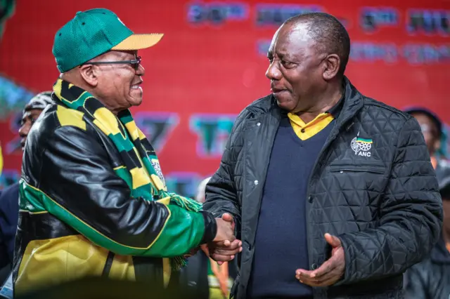 South African President Jacob Zuma (L) and South African Deputy President Cyril Ramaphosa (R) shake hands as they arrive to attend the opening session of the South African ruling party African National Congress (ANC) policy conference on June 30, 2017 in Johannesburg.