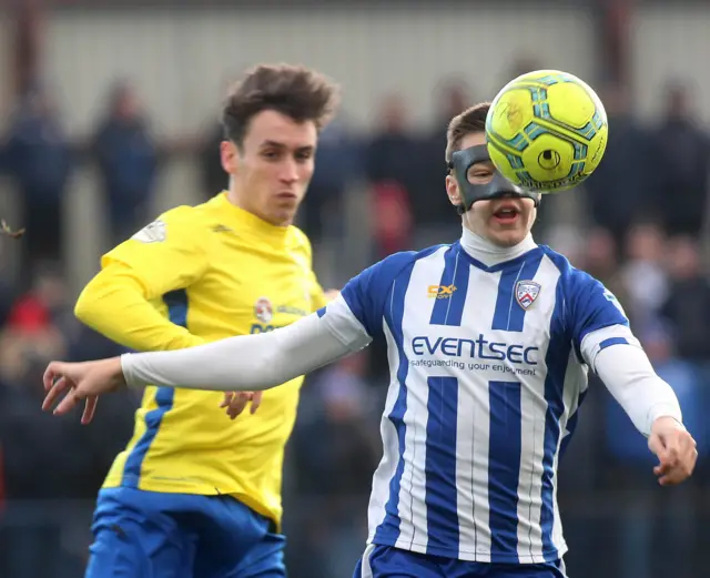 Coleraine midfielder Brad Lyons gets in front of Dungannon's Grant Hutchinson