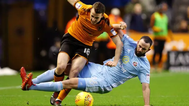 Sunderland defender Marc Wilson tackles Wolves forward Diogo Jota