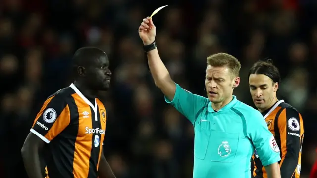 Oumar Niasse is shown a yellow card