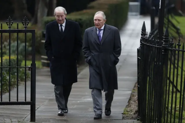 Former manager Howard Wilkinson (R) arrives for the funeral service of former England