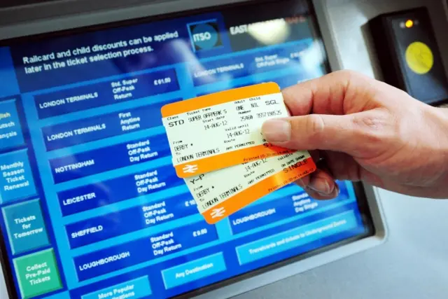 Man holding rail tickets