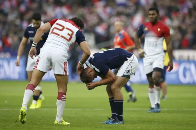 Yoann Huget offers commiserations to Huw Jones