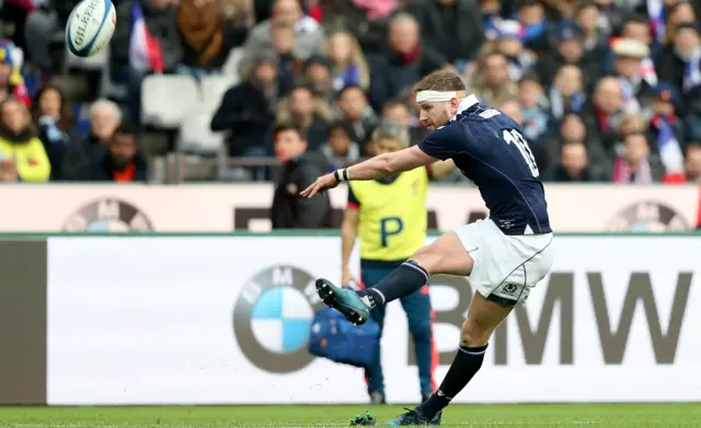 Finn Russell kicks a penalty