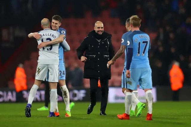 Manchester City players celebrate with manager Pep Guardiola