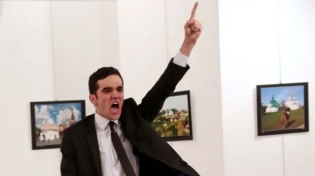 Mevlut Mert Altintas shouts after shooting Andrei Karlov the Russian ambassador to Turkey, at an art gallery in Ankara, Turkey December 19, 2016. Burhan Ozbilici