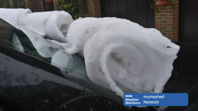 Snow furls on a car windscreen