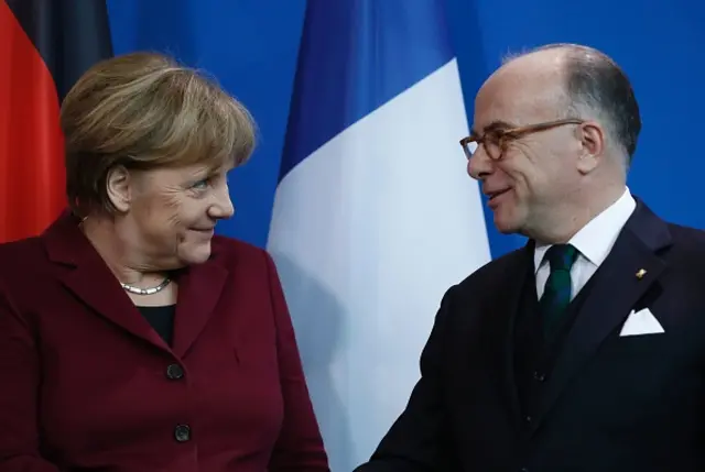 Angela Merkel (L) and Bernard Cazeneuve (R)