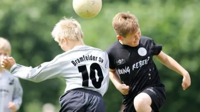 Children heading a football