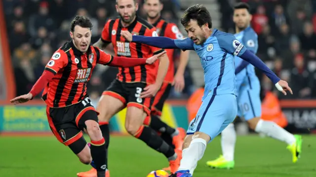 David Silva, of Manchester City, shoots but is blocked by Adam Smith