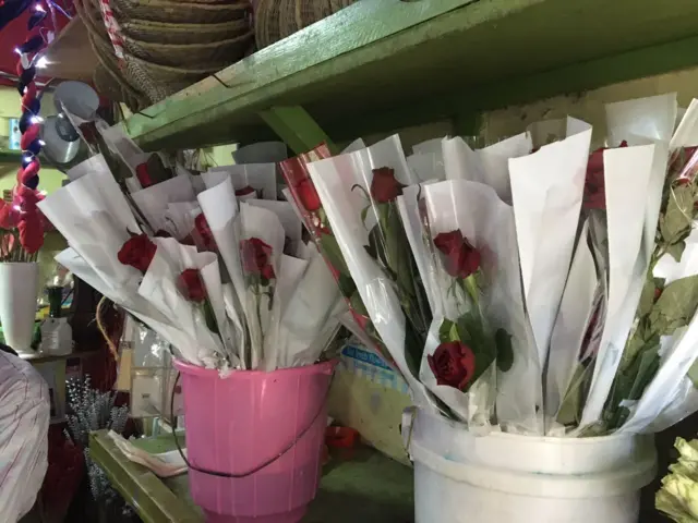 Buckets of red roses