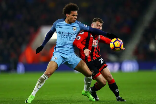 Leroy Sane of Manchester City battles for the ball with Ryan Fraser of Bournemouth