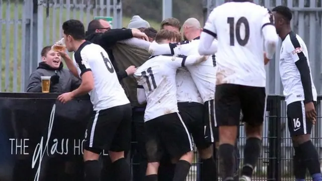 Corby Town defender Jason Lee takes a swig of cider during his side's 1-0 win over Mickleover Sports