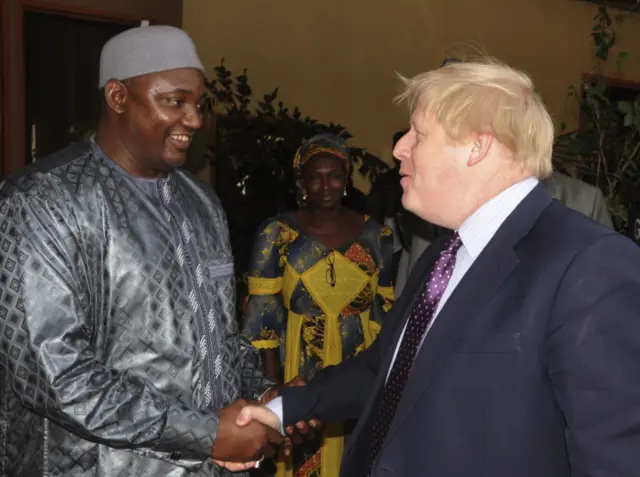 Britain"s Foreign Secretary Boris Johnson, right, shakes hands with Gambian President Adama Barrow as they meet for talks in Banjul,