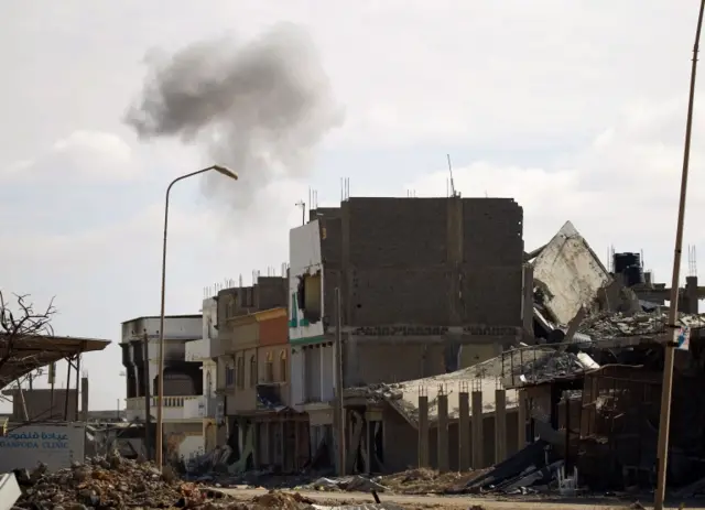 Smoke billows on January 28, 2017 in the area of Qanfudah, on the southern outskirts of Benghazi, after members of the Libyan National Army (LNA), also known as the forces loyal to Marshal Khalifa Haftar, retook it from Islamic State (IS) fighters.