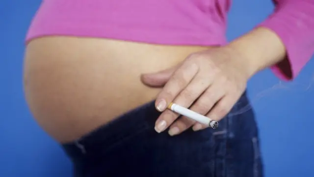 Pregnant woman holding a cigarette