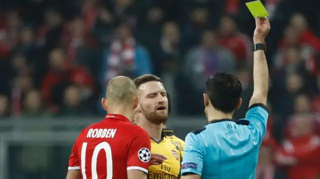 Shkodran Mustafi is shown a yellow card