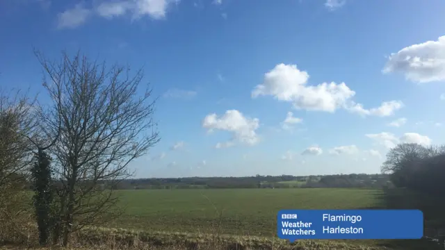 Blue sky with a few clouds over open landscape